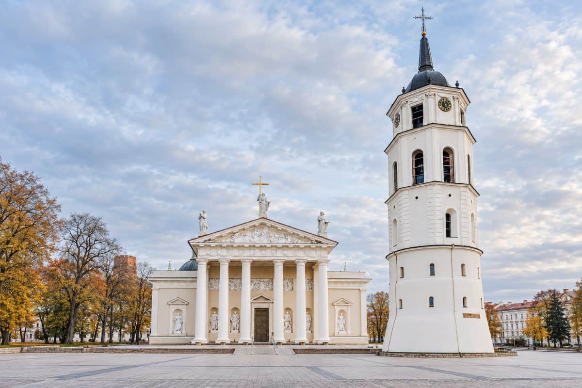 Lithuania hosts hotrec vote as european hospitality now seeks to give hotels more of a voice in eu policy - travel and tour world Vilnius cathedral and its white bell tower overlooking an empty cathedral square, framed by autumn trees and historic buildings