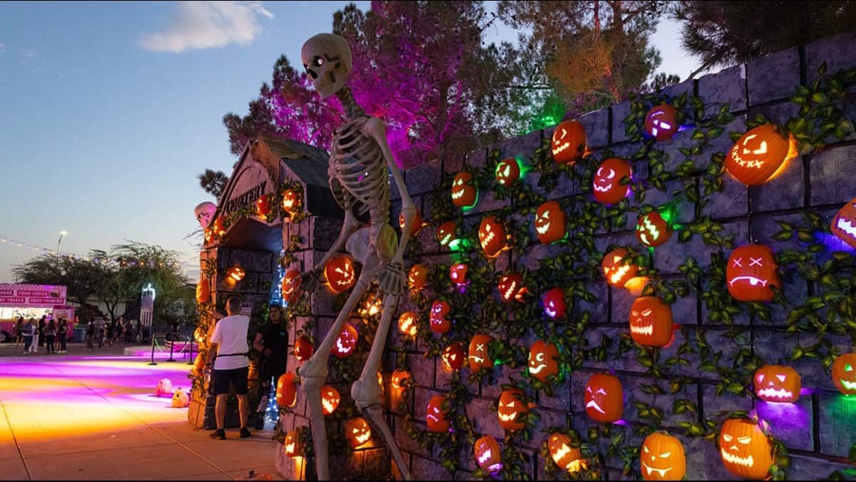 Halloween pumpkin display and giant skeleton at a nevada seasonal attraction.