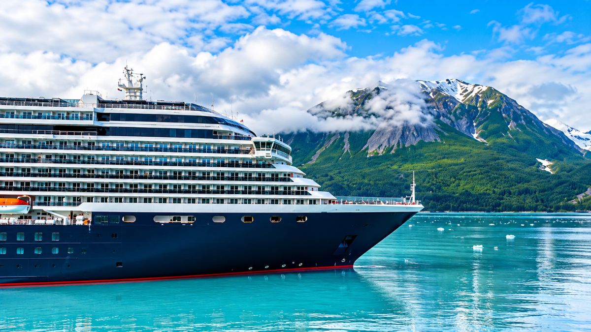 Holland america line cruise vessel sailing through scenic norwegian fjords during a northern european voyage.