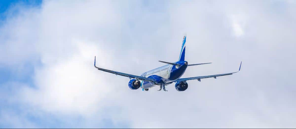 Indigo - travel and tour world Indigo aircraft and udaipur lake pichola illustrating new direct flights from noida and navi mumbai.