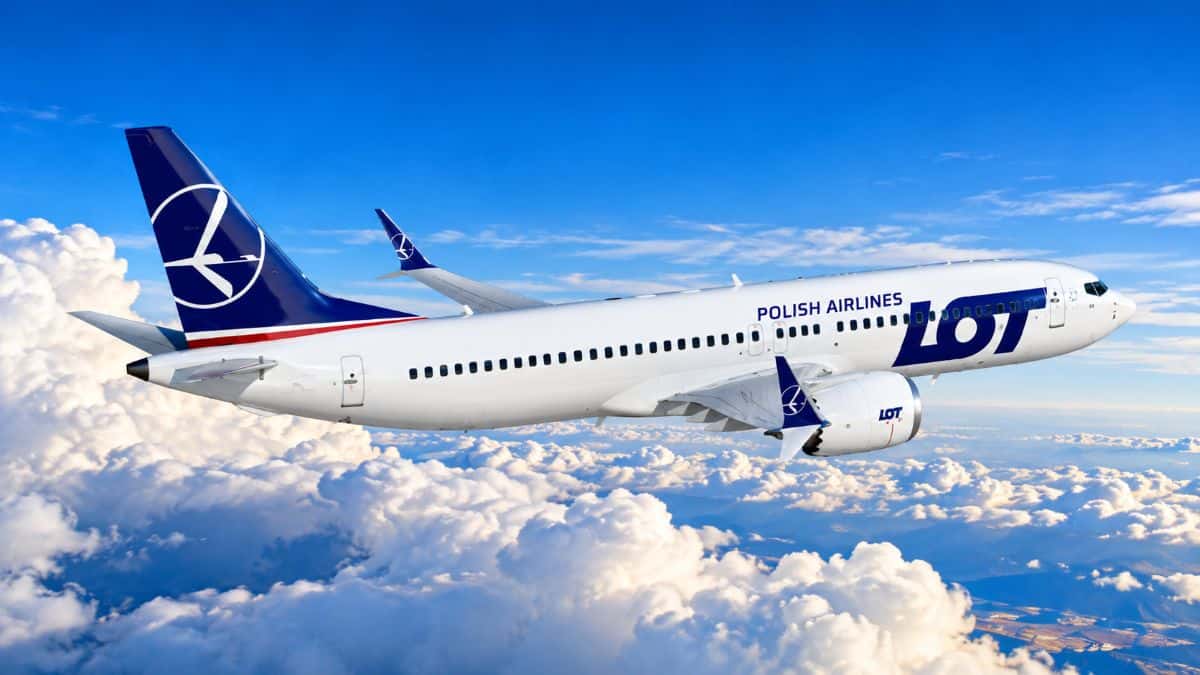Lot polish airlines above the clouds - travel and tour world A lot polish airlines boeing 787 dreamliner preparing for a long-haul charter flight on an airport tarmac.