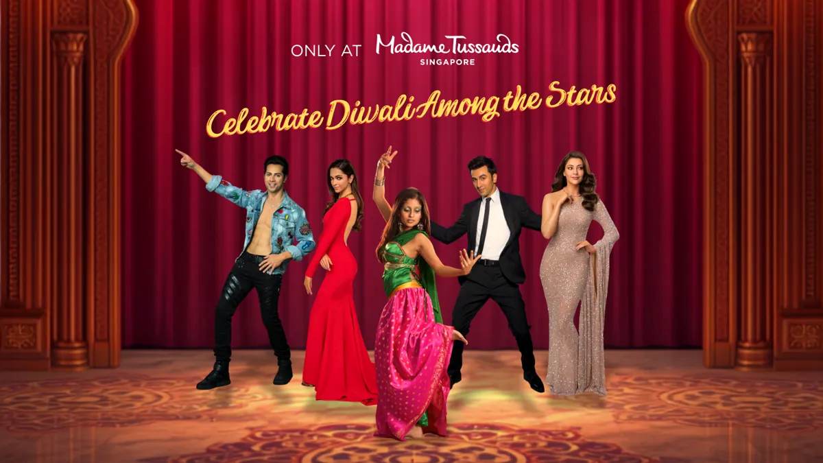 Lifelike wax figure of indian cinema star deepika padukone wearing an open-back red floor-length gown featured at the madame tussauds singapore icons of india exhibition.