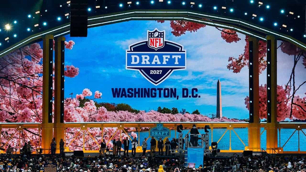 Nfl - travel and tour world Nfl draft 2027 stage in washington, dc, featuring cherry blossoms, the washington monument and a large crowd.