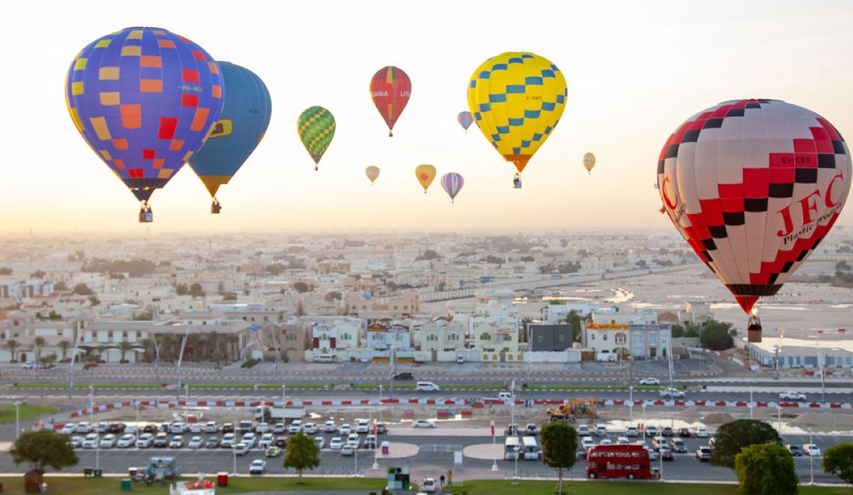 Qatar balloon festival - travel and tour world Colourful hot-air balloons and illuminated night glow displays at a qatar winter festival.