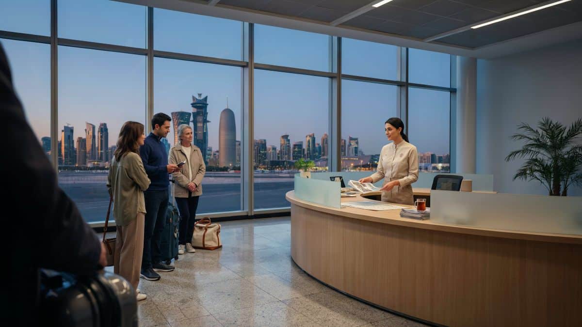Qatar tourism - travel and tour world International travellers speak with a tourism staff member at a stopover desk in doha airport.