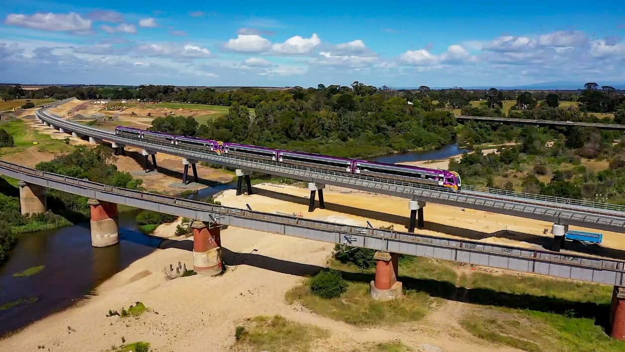 Vlocity train - travel and tour world Vlocity passenger train crossing the avon river bridge at stratford in gippsland, victoria.