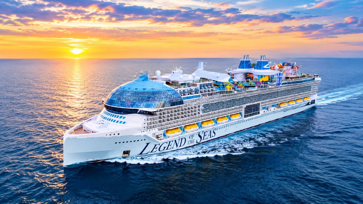 Royal caribbean cruise ship navigating the scenic waters of alaska near towering glaciers and coastal pine forests - travel and tour world Royal caribbean cruise ship navigating the scenic waters of alaska near towering glaciers and coastal pine forests.