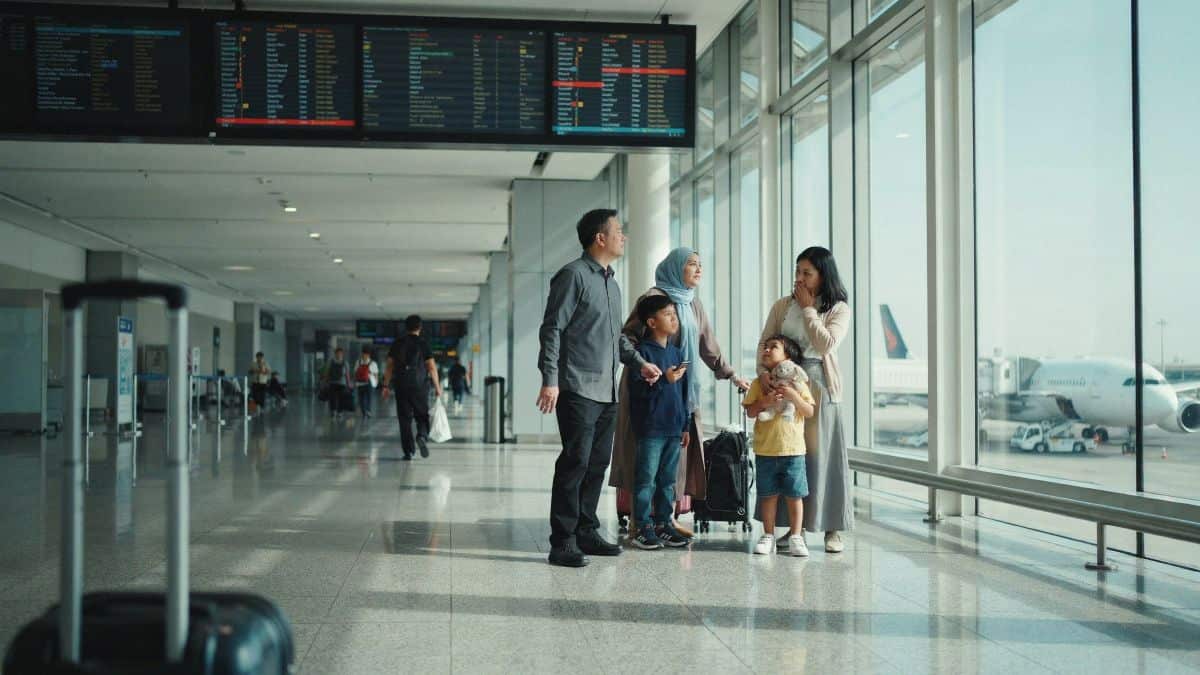 Asian passengers check flight information at an airport in riyadh.