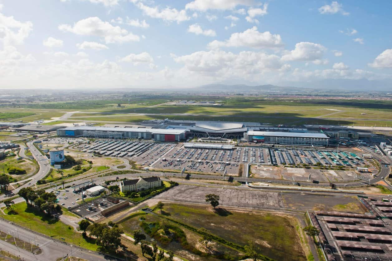 Aerial view of cape town international airport terminal, aircraft and access roads in south africa.