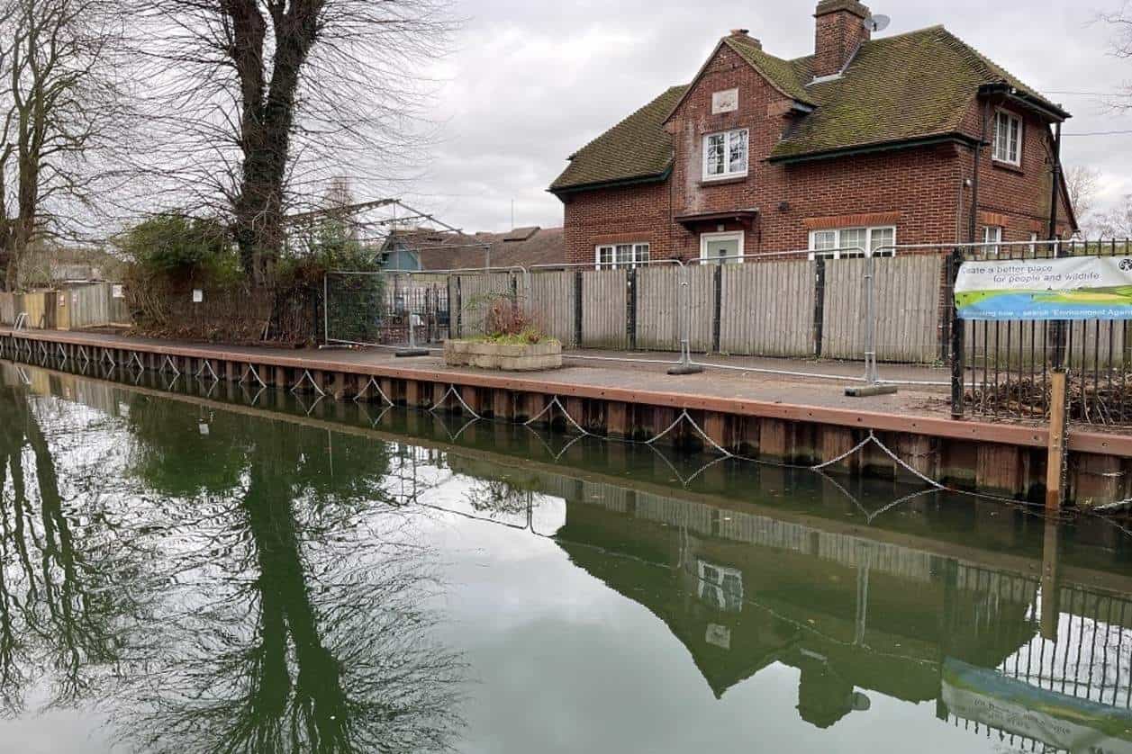Archive view of timber fenders and grab chains beside the water ahead of the caversham lock reopening.