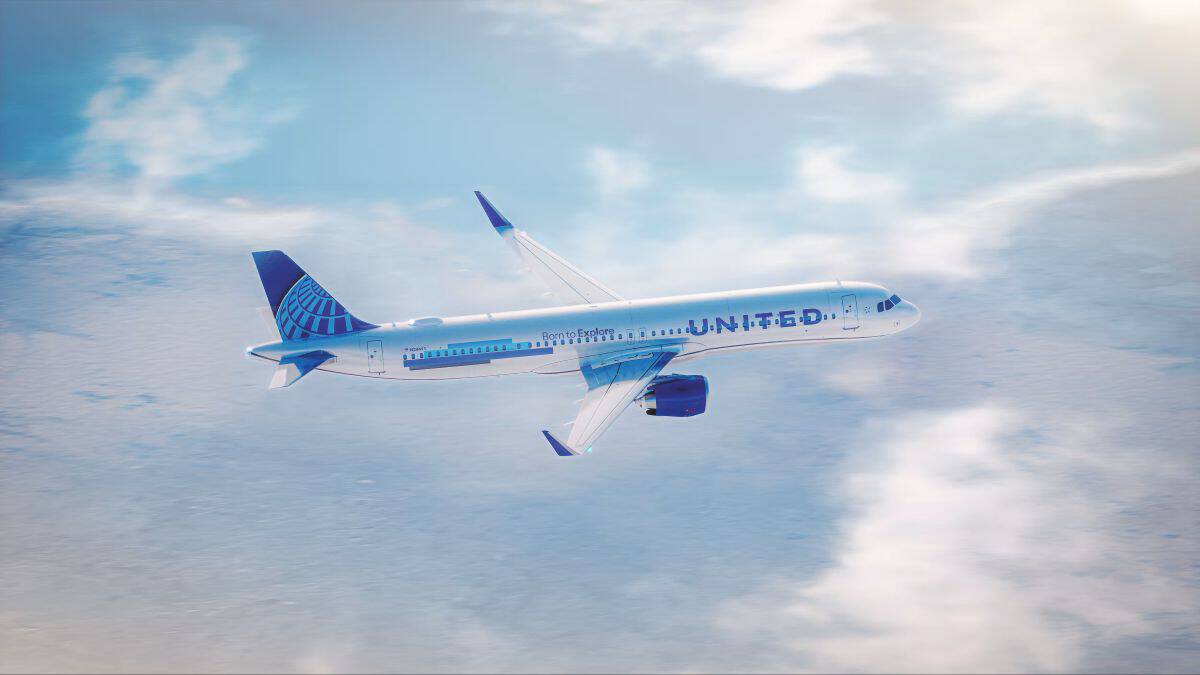 United airlines passenger aircraft flying above the clouds.