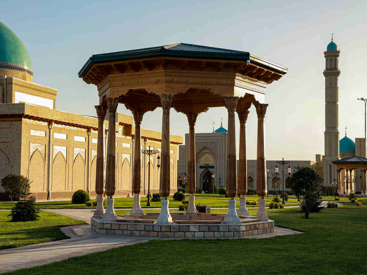 Uzbekistan heritage amid global economic challenges - travel and tour world Traditional uzbek architecture with turquoise domes and mosque courtyard in uzbekistan.