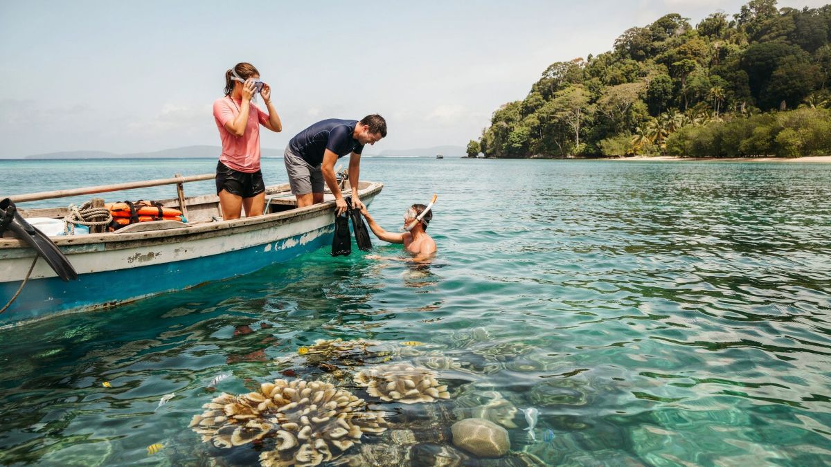 Travellers prepare to snorkel off espiritu santo in vanuatu.