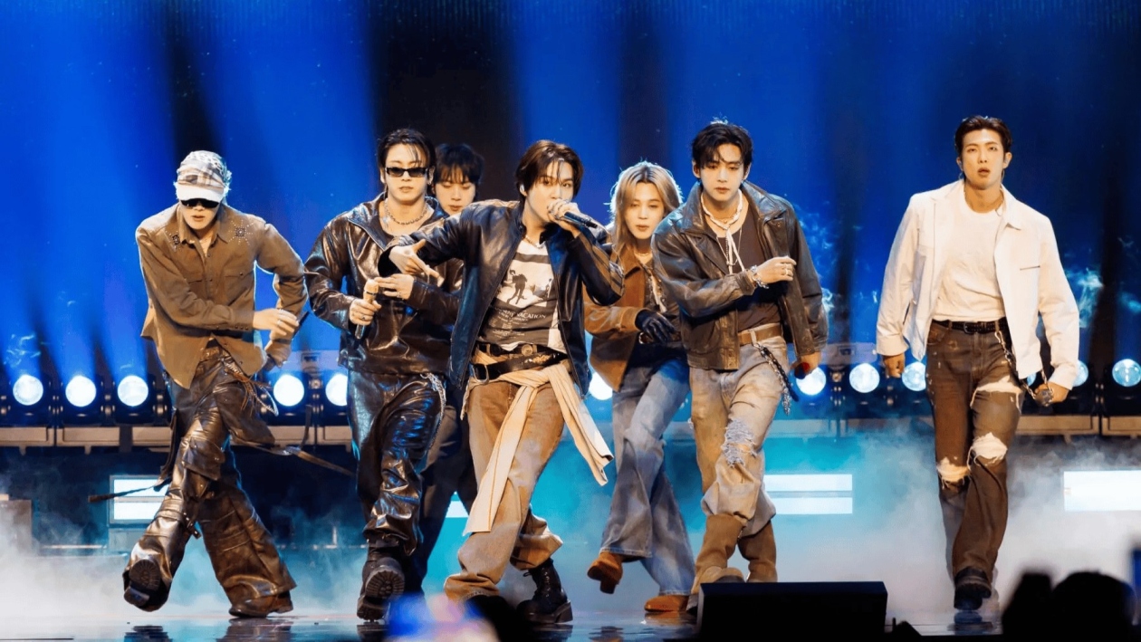 Bts-arirang-world-tour-2026-south-america-music-tourism - travel and tour world Bts members perform together on stage under blue lights, highlighting the global appeal of the arirang world tour.