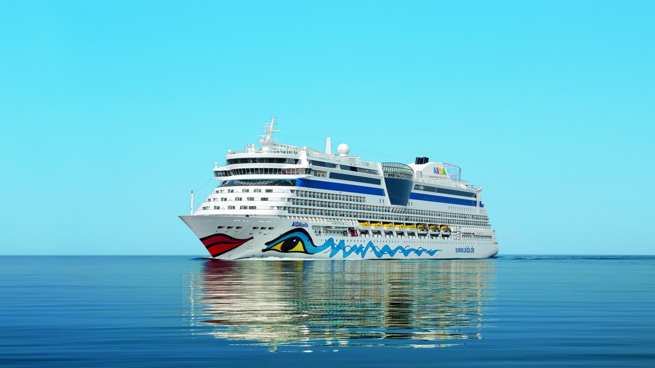 Aida - travel and tour world Aidamar cruise ship at warnemünde port in germany ahead of its planned 142-day aida world cruise in 2028, visiting 51 ports across five continents.