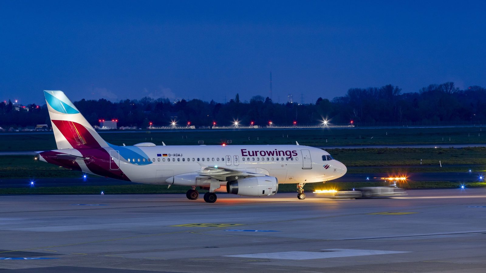 Eurowings-airbus-a319-newcastle-berlin-direct-flights-2027 - travel and tour world Eurowings airbus a319 aircraft taxiing at dusk ahead of newcastle–berlin flights in 2027.