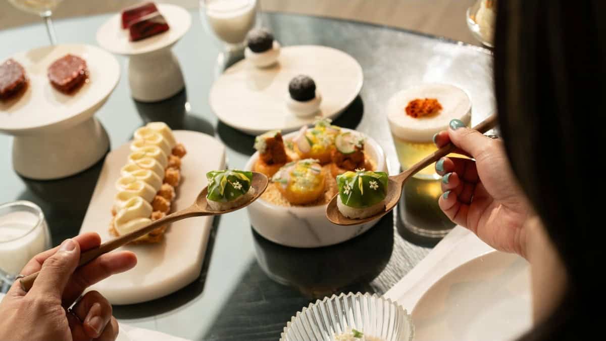 Thai-inspired afternoon tea at four seasons hotel bangkok with savoury bites, pastries and desserts.
