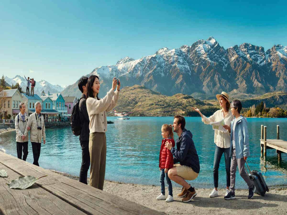 New zealand tourism recovery 2026 - travel and tour world International tourists exploring queenstown amid new zealand's tourism recovery in 2026.