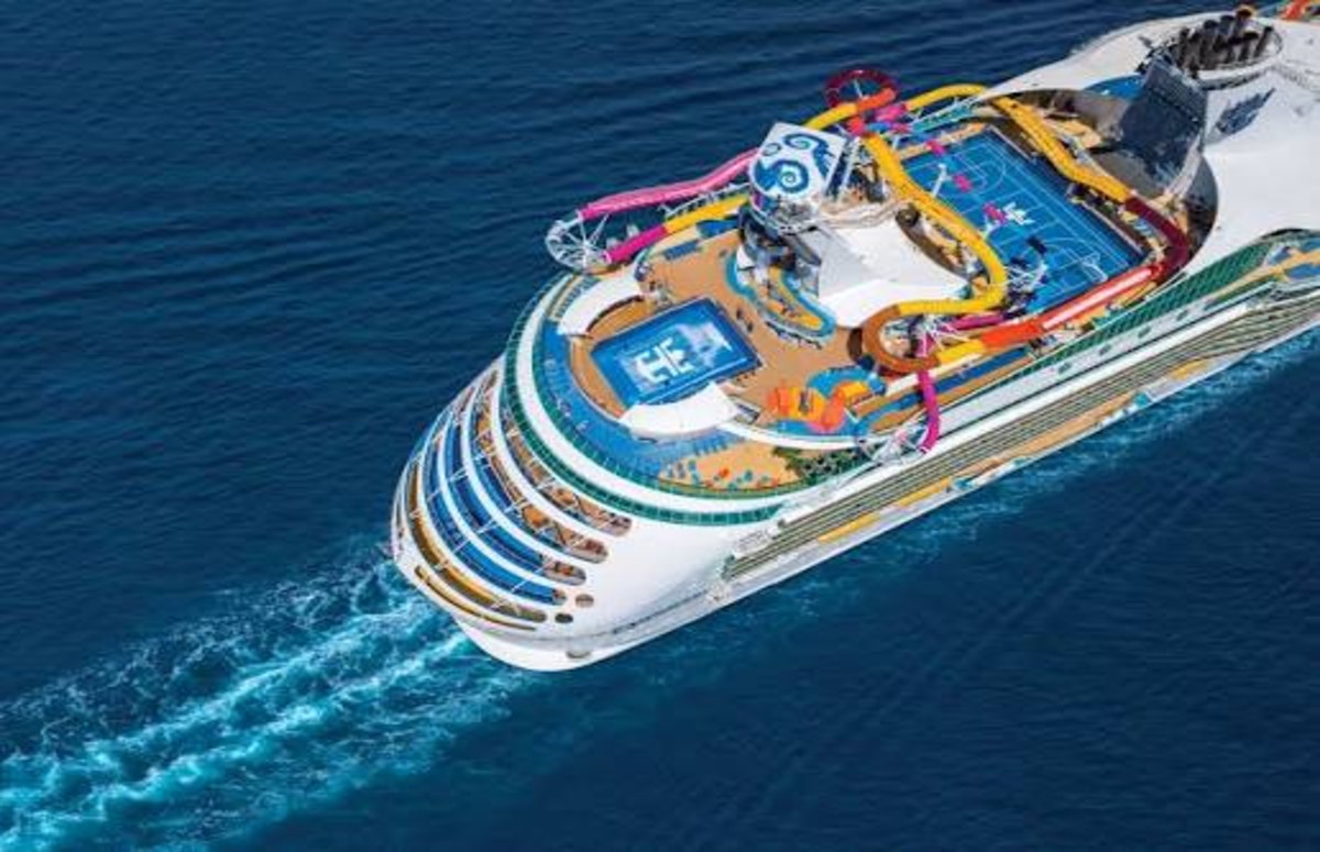 Royal caribbean cruise ship sailing through alaska with mountains and glaciers during the summer cruise season