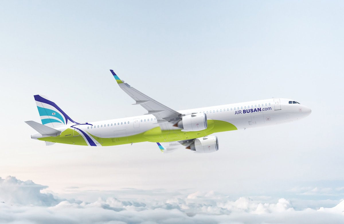 Air busan airbus a321neolr aircraft displaying its official blue-and-white branding at gimhae international airport in south korea.