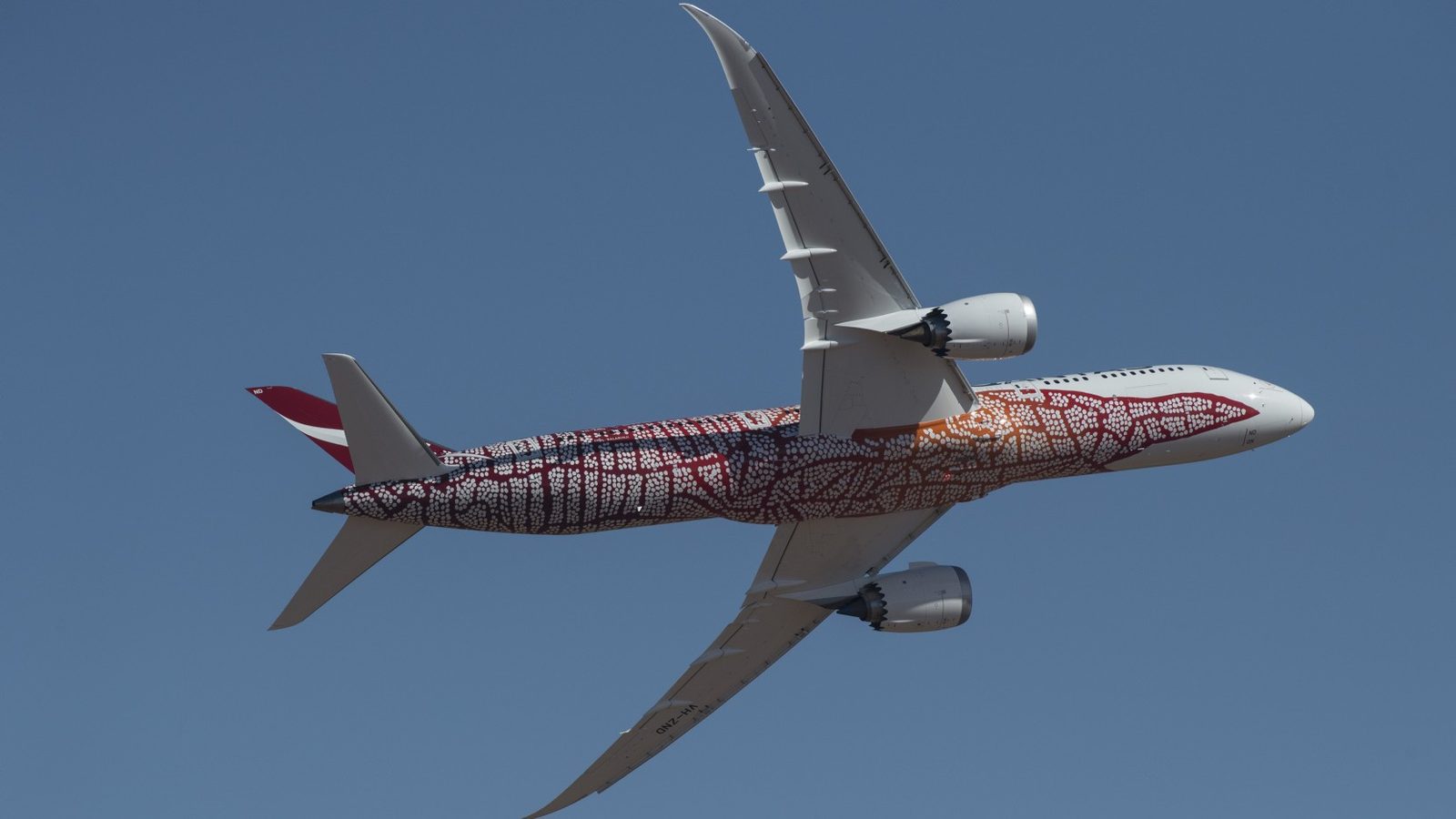 Qantas-pacific-islands-sale-discounted-flights-dreamliner - travel and tour world Qantas dreamliner with indigenous artwork flying overhead