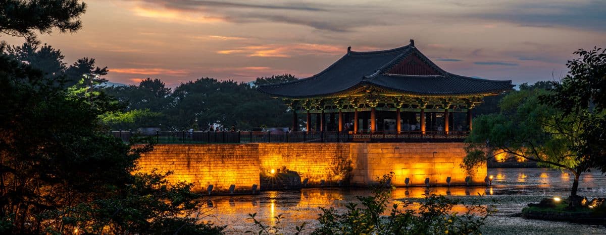 S korea - travel and tour world Donggung palace pavilion in gyeongju, south korea, illuminated against a colourful sunset sky.
