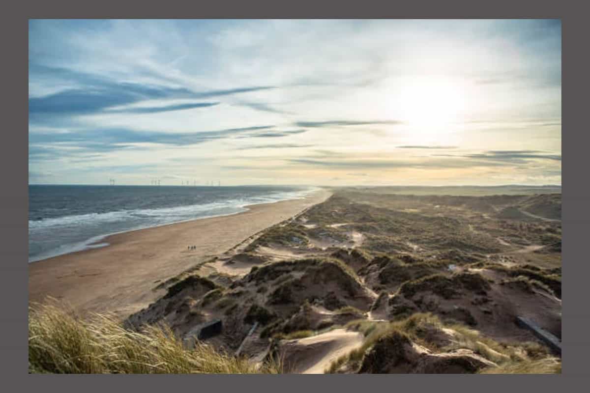 Balmedie beach - travel and tour world Sun coming down at a rocky seaside beach