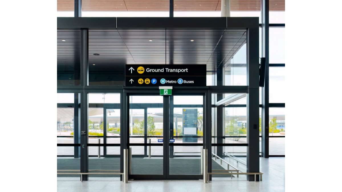 Western-sydney-international-airport-ground-transport-accessibility-facilities - travel and tour world Western sydney international airport ground transport entrance with accessible pathways and clear signage.